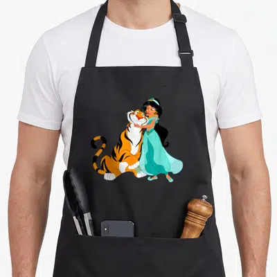 Jasmine princess apron - Cartoon princess in turquoise dress hugging a large orange and black tiger — shown on a black cotton canvas apron against a white background