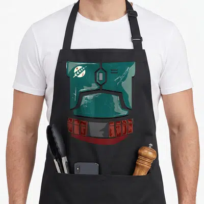 Costume food halloween apron - Teal robot head armor with red belt blocks, circular emblem, and horizontal lines — shown on a black cotton canvas apron against a white background