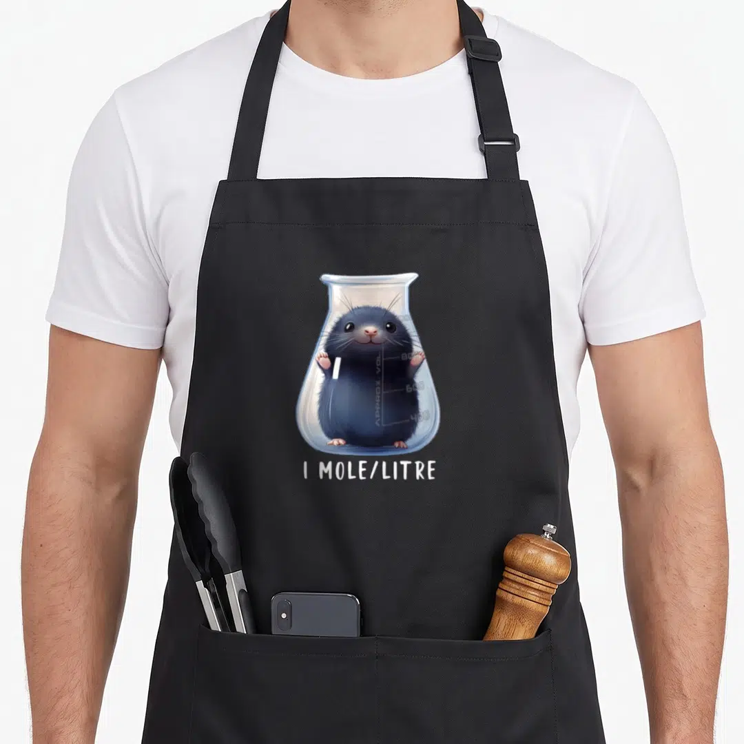 Student mole chemistry apron - Cartoon mole inside Erlenmeyer flask with 1 MOLE/LITRE text in grey blue white — shown on a black cotton canvas apron against a white background