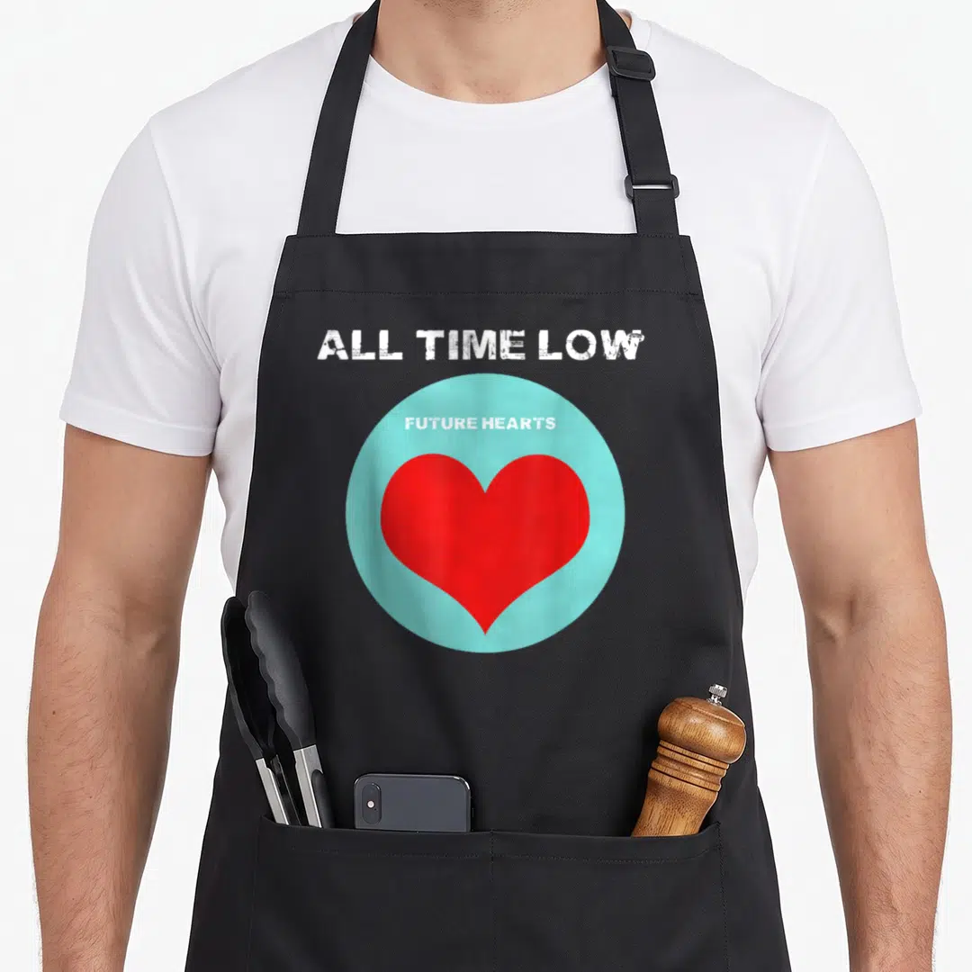 Future band apron - All Time Low text above a light blue circle containing a red heart and Future Hearts label — shown on a black cotton canvas apron against a white background