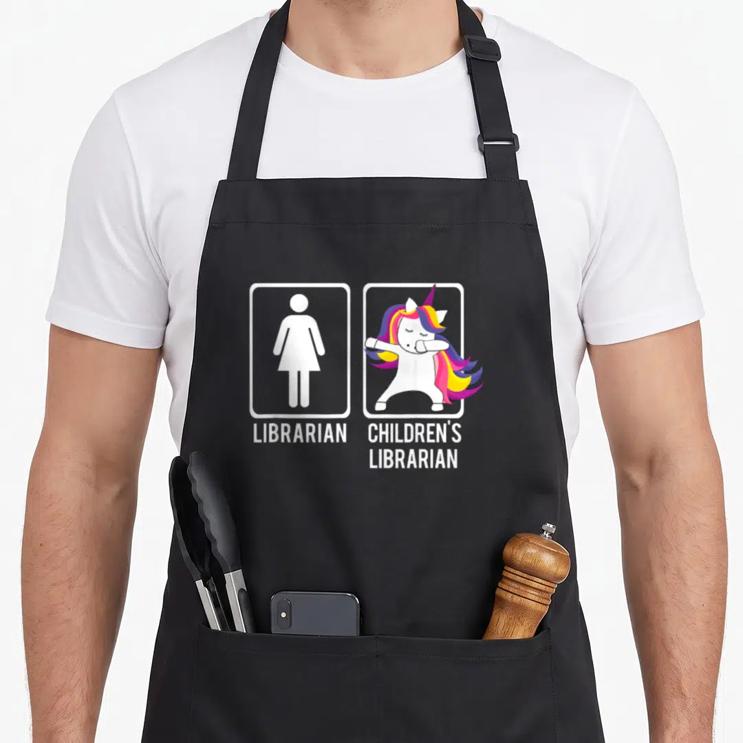 Dabbing meme apron - Cartoon unicorn dabbing next to female symbol with text Librarian and Children's Librarian — shown on a black cotton canvas apron against a white background