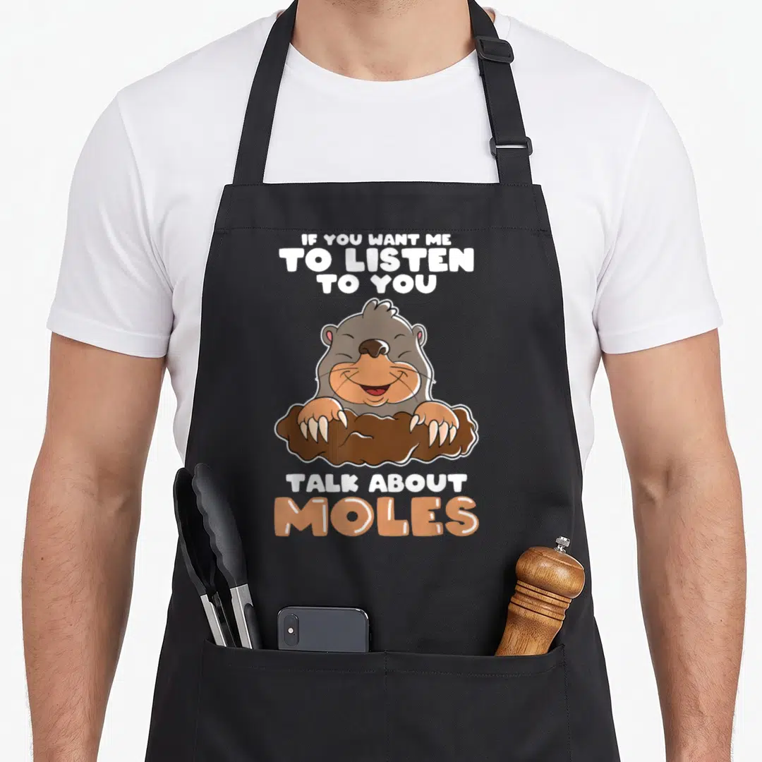 Talk hunter apron - Cartoon mole in dirt with text IF YOU WANT ME TO LISTEN TO YOU TALK ABOUT MOLES — shown on a black cotton canvas apron against a white background