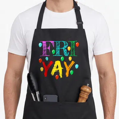 Friyay teacher apron - Stacked FRI YAY text in purple blue green red yellow orange with scattered balloons — shown on a black cotton canvas apron against a white background