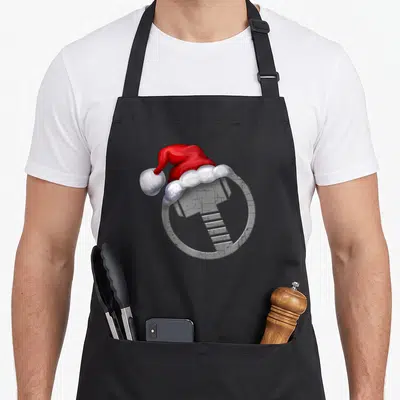 Hammer christmas santa apron - Grey hammer in circle wearing red and white santa hat — shown on a black cotton canvas apron against a white background