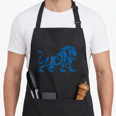 Blue detroit apron - Blue lion shape made of LION text and 313 numbers — shown on a black cotton canvas apron against a white background
