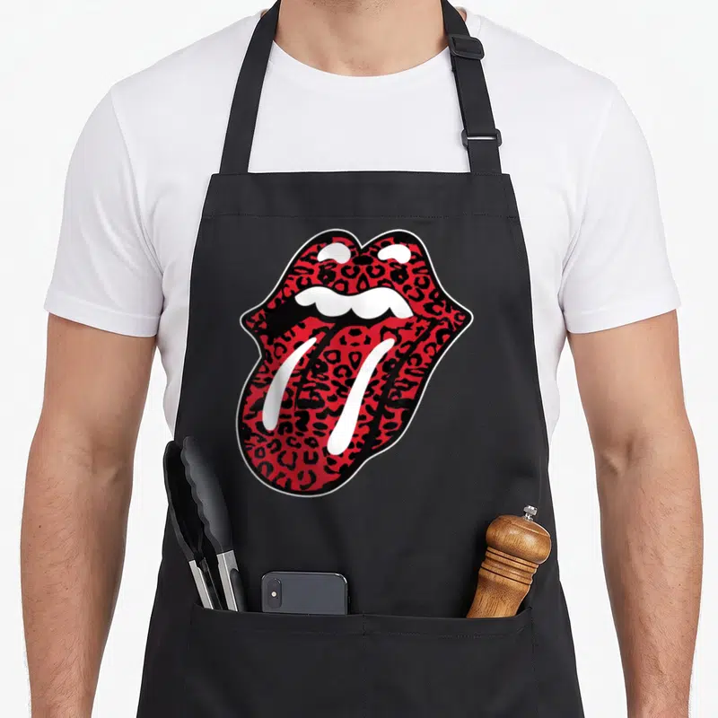 Tongue leopard apron - Red and black leopard print open mouth graphic outlined in white and black — shown on a black cotton canvas apron against a white background