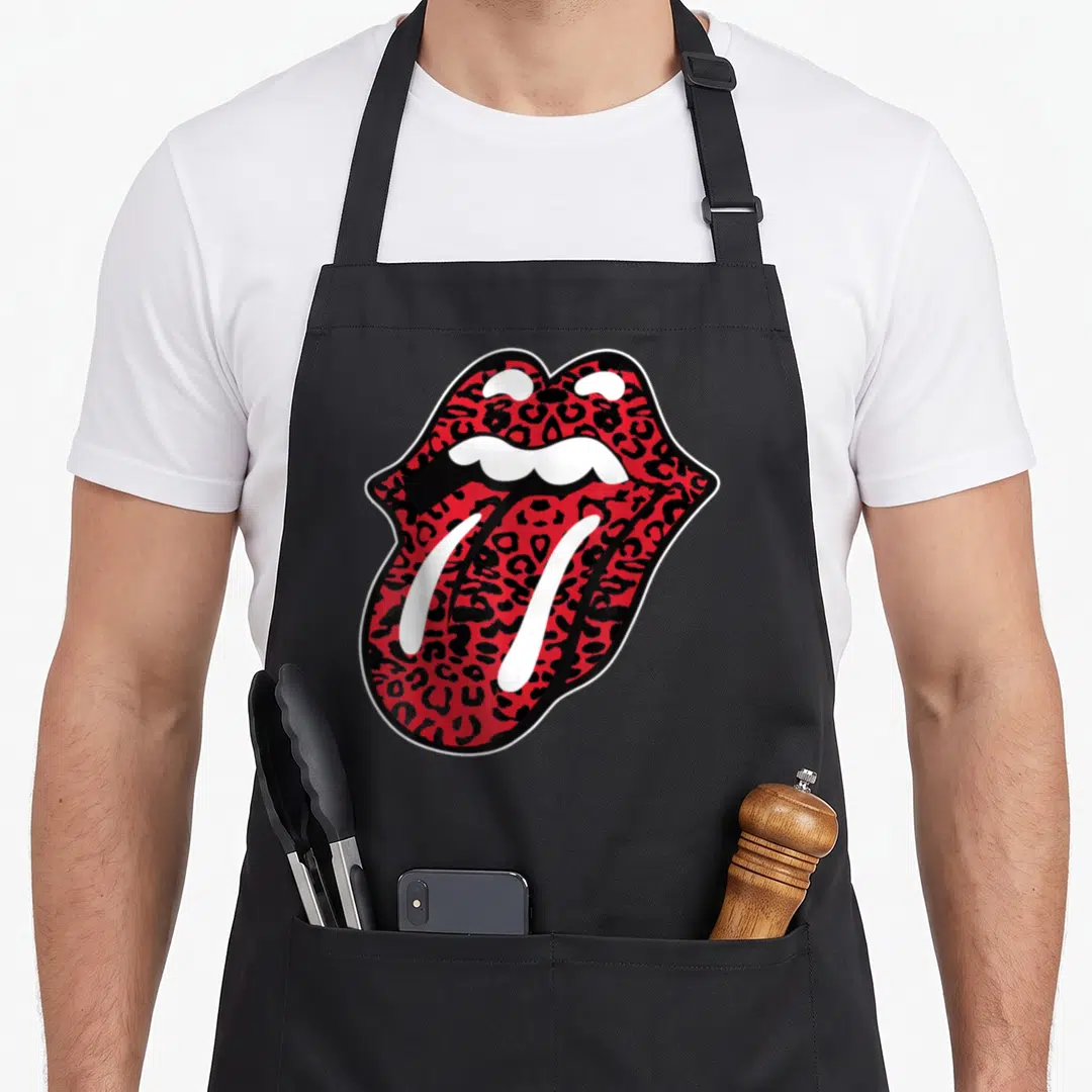 Tongue leopard apron - Red and black leopard print open mouth graphic outlined in white and black — shown on a black cotton canvas apron against a white background