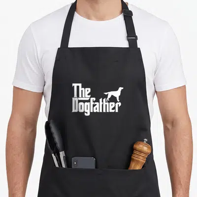 Dogfather irish dog apron - White stacked text The Dogfather with standing dog silhouette — shown on a black cotton canvas apron against a white background