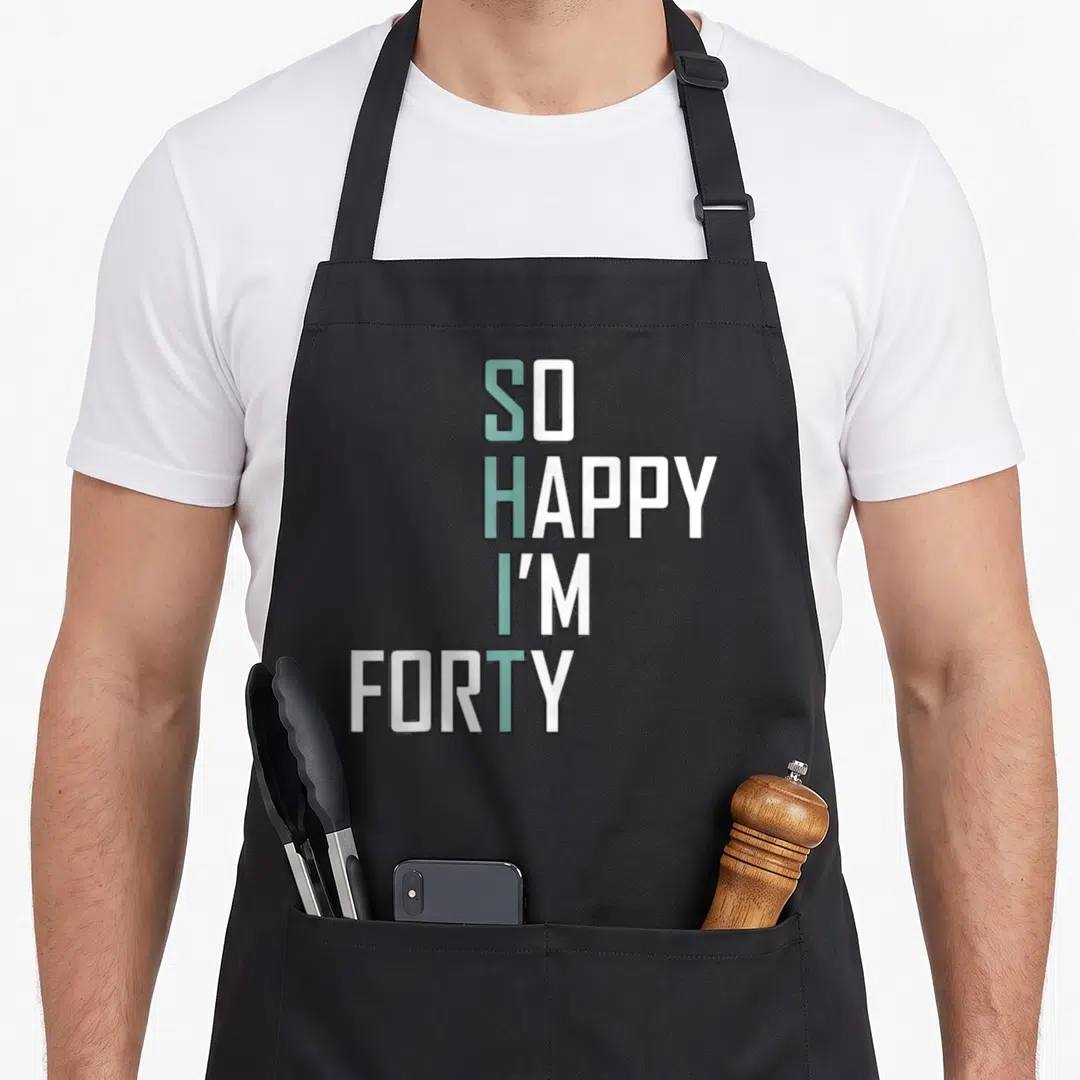 Bday 40th birthday apron - SO HAPPY I'M FORTY text in white and light blue stacked typography — shown on a black cotton canvas apron against a white background
