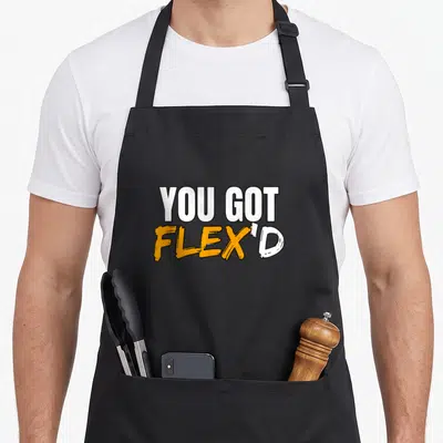 Flexd courier apron - YOU GOT FLEX'D white orange black stacked typography design — shown on a black cotton canvas apron against a white background