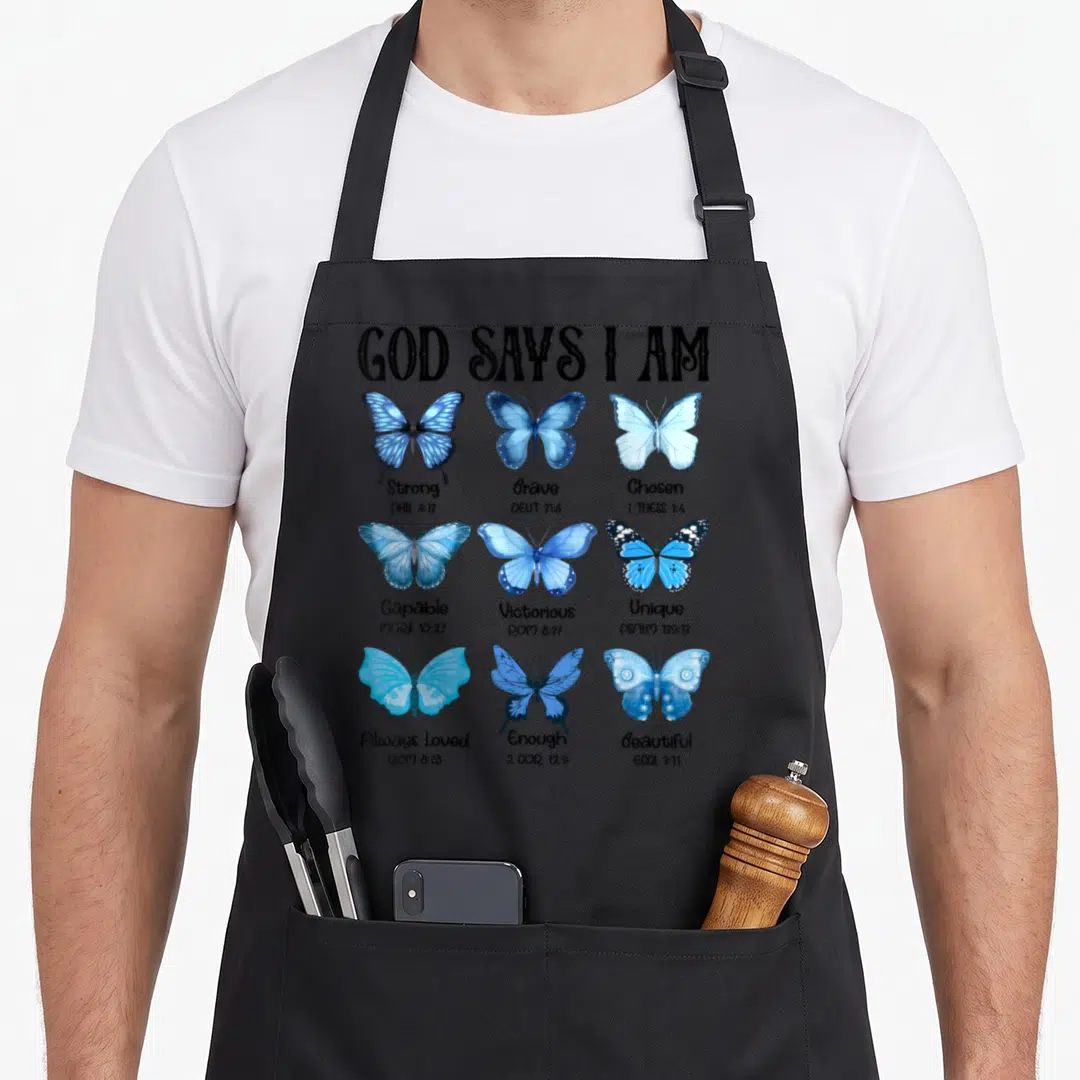 Butterfly god says i am apron - Nine blue watercolor butterflies with GOD SAYS I AM header and scripture references — shown on a black cotton canvas apron against a white background