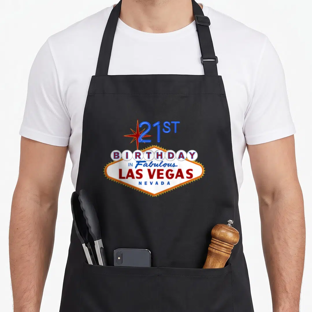 21st las birthday apron - Retro sign reading 21ST BIRTHDAY IN Fabulous LAS VEGAS NEVADA with star and diamond shape — shown on a black cotton canvas apron against a white background