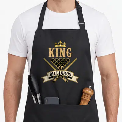 Billiard king apron - Retro crest with gold crown, tan KING text, black balls, crossed cues, and cream BILLIARDS ribbon — shown on a black cotton canvas apron against a white background