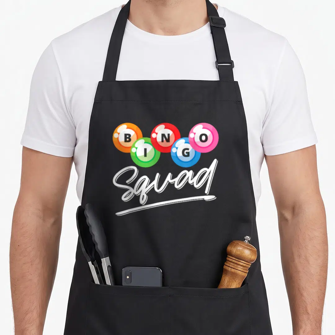 Squad bingo apron - Five colored bingo balls spelling BINGO above white Squad script — shown on a black cotton canvas apron against a white background