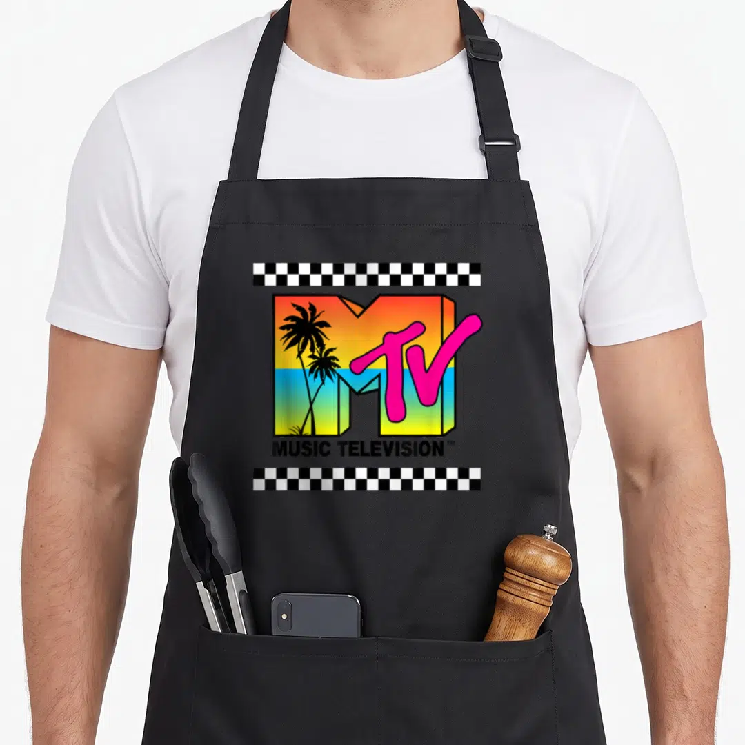 Mtv vintage sunset apron - MTV logo with palm trees, sunset gradient, checkerboard strips, and MUSIC TELEVISION text — shown on a black cotton canvas apron against a white background
