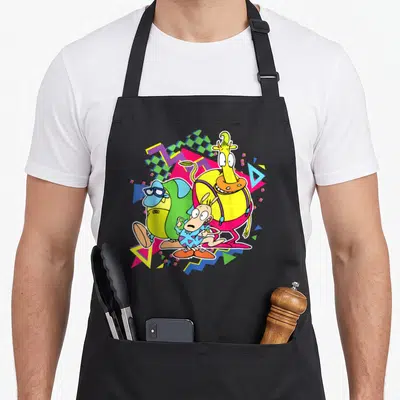 90s modern apron - Three cartoon monsters surrounded by yellow pink green blue purple geometric shapes and zigzags — shown on a black cotton canvas apron against a white background