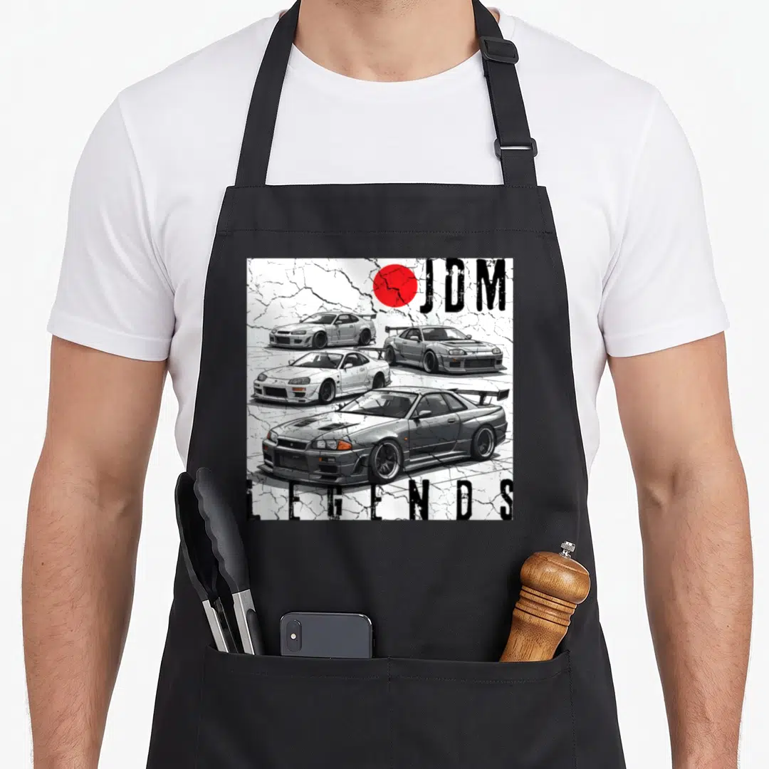 Backprint car apron - Three stacked JDM race cars with red circle and cracked white background — shown on a black cotton canvas apron against a white background