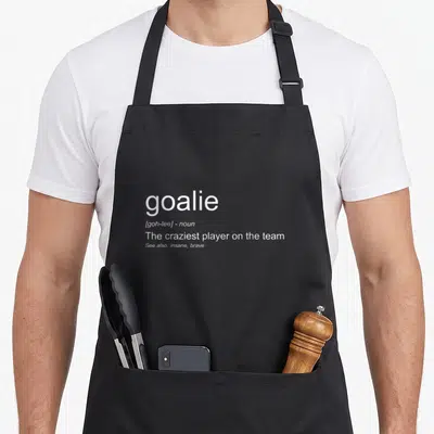 Goalkeeper football ice apron - White text defining goalie as the craziest player on the team — shown on a black cotton canvas apron against a white background