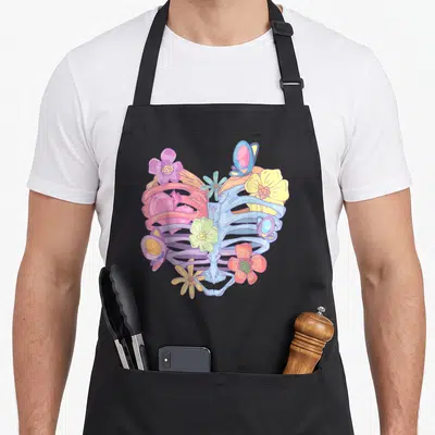 Pastel butterfly apron - Cartoon ribcage in blue purple yellow pink and red with flowers and butterflies — shown on a black cotton canvas apron against a white background