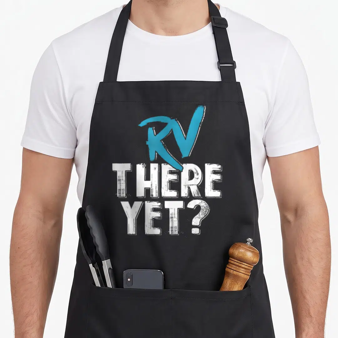 Camper road apron - Blue RV brushstroke above distressed white text reading THERE YET — shown on a black cotton canvas apron against a white background