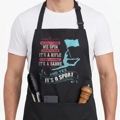 Band point guard apron - Stacked text correcting twirl vs spin terms next to a blue flag bearer silhouette — shown on a black cotton canvas apron against a white background