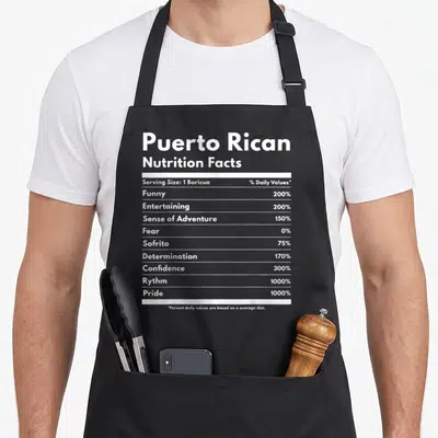Crew pride apron - White nutrition label listing 1000% Pride, 0% Fear, and 1 Boricua serving size — shown on a black cotton canvas apron against a white background