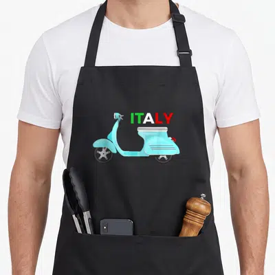 Italy scooter italian apron - Light blue cartoon scooter with green white and red ITALY text — shown on a black cotton canvas apron against a white background