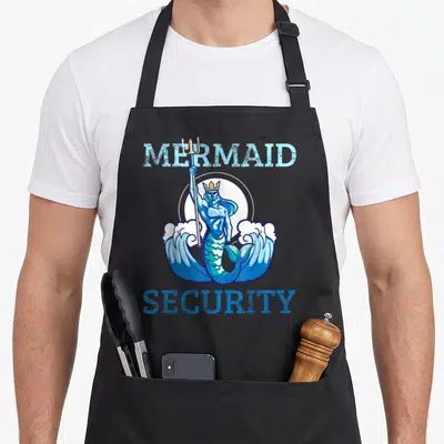 Swimmer birthday apron - Cartoon merman holding trident with MERMAID SECURITY text in blue and teal — shown on a black cotton canvas apron against a white background