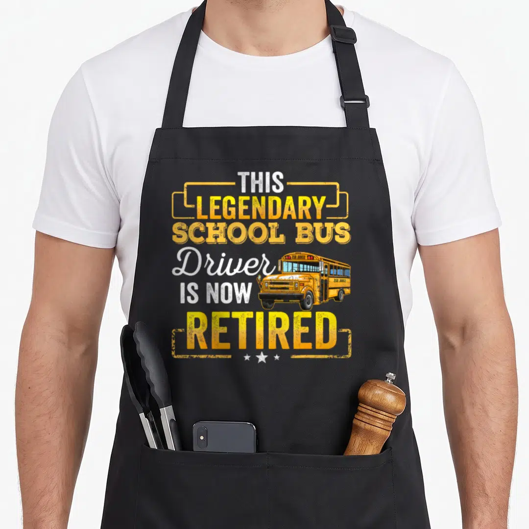 Retired bus driver apron - Yellow school bus with stacked retired driver text and three stars — shown on a black cotton canvas apron against a white background