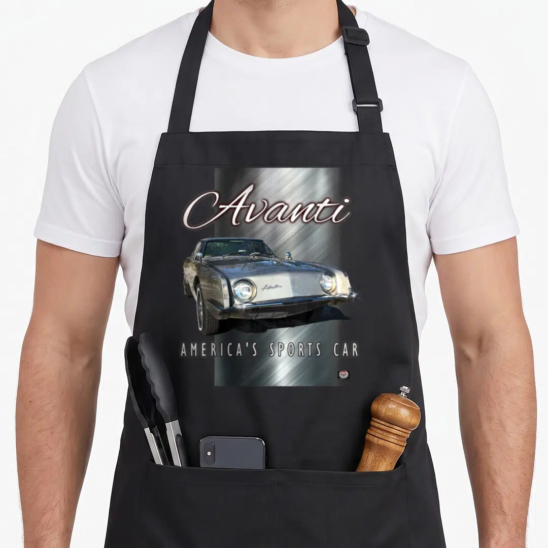 Avanti car apron - Silver Studebaker Avanti photo on brushed metal background with text — shown on a black cotton canvas apron against a white background