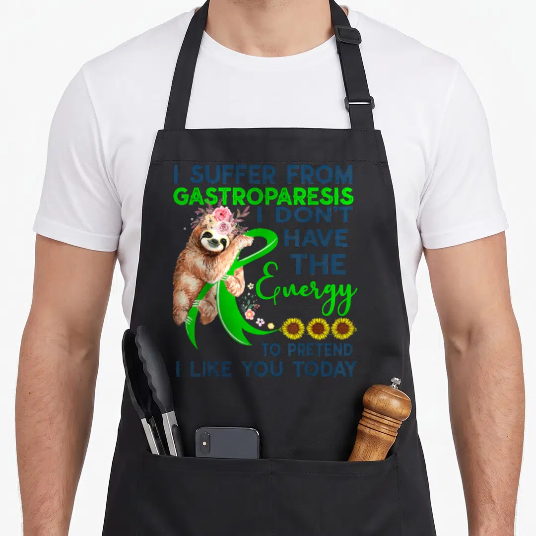 Gastroparesis sloth apron - Cartoon sloth with pink flowers holding green ribbon next to blue text and yellow sunflowers — shown on a black cotton canvas apron against a white background