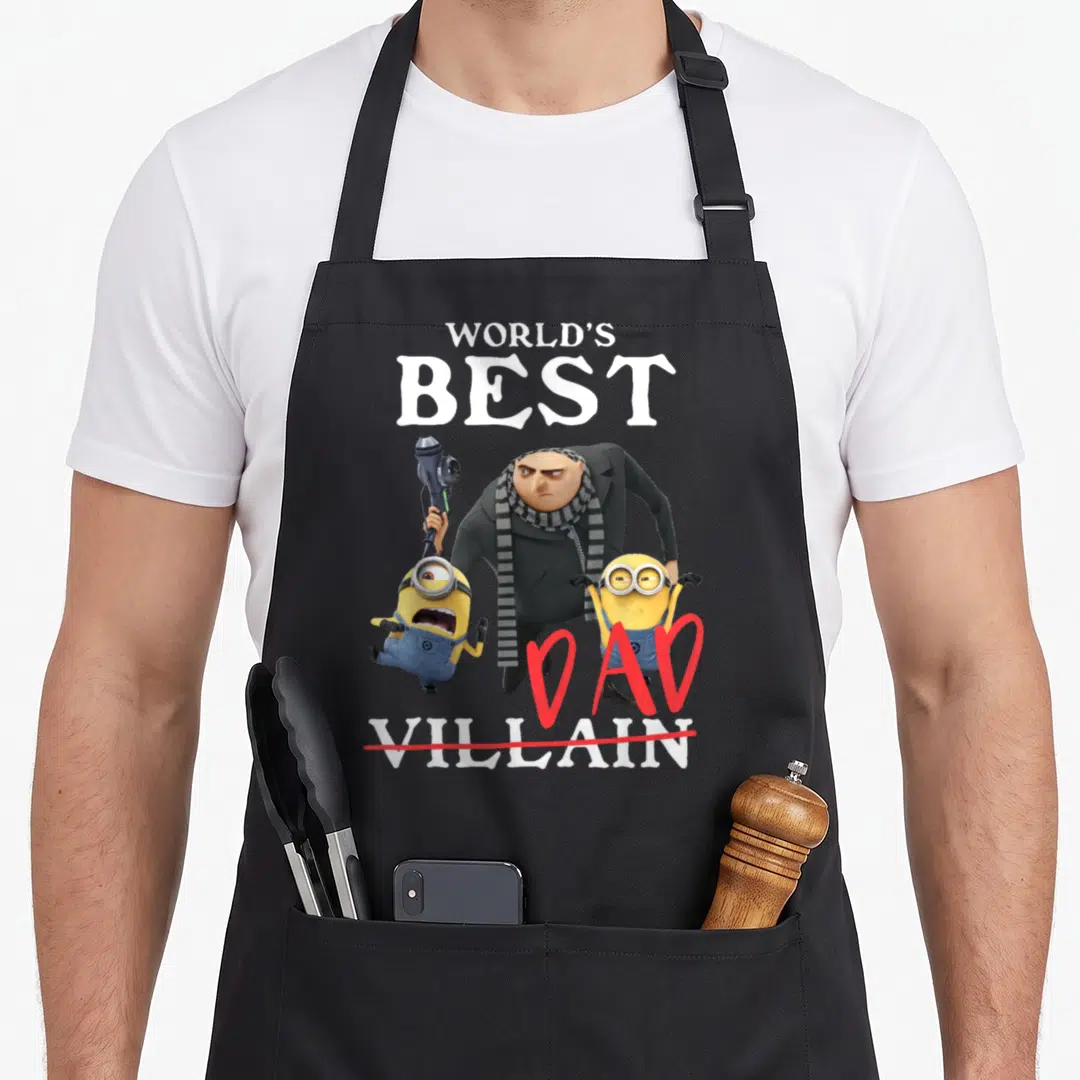 Villain father day apron - Gru and two minions with World's Best Dad Villain text and red strikethrough — shown on a black cotton canvas apron against a white background