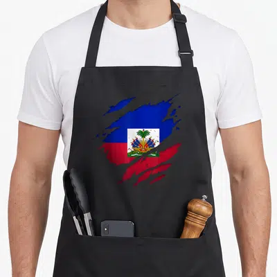 Haitian torn apron - Distressed Haitian flag print with blue red white torn edges on black apron — shown on a black cotton canvas apron against a white background