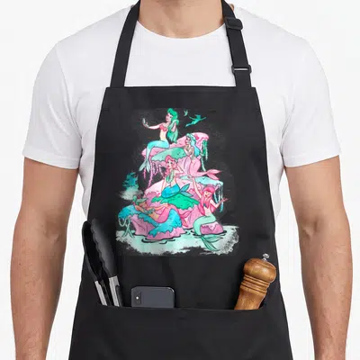 Peter mermaid apron - Four watercolor mermaids on pink coral with teal seaweed and small birds — shown on a black cotton canvas apron against a white background