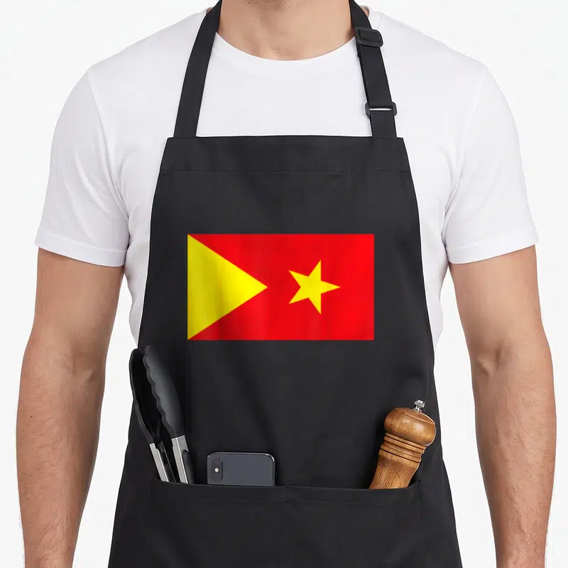 Tigray ethiopian boy apron - Red rectangular flag with yellow triangle and star centered on fabric — shown on a black cotton canvas apron against a white background