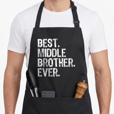 Middle crazy better apron - White stacked text reading BEST. MIDDLE BROTHER. EVER. on grey background — shown on a black cotton canvas apron against a white background