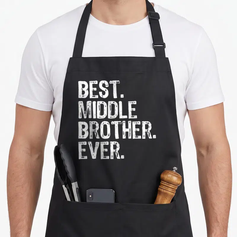 Middle crazy better apron - White stacked text reading BEST. MIDDLE BROTHER. EVER. on grey background — shown on a black cotton canvas apron against a white background