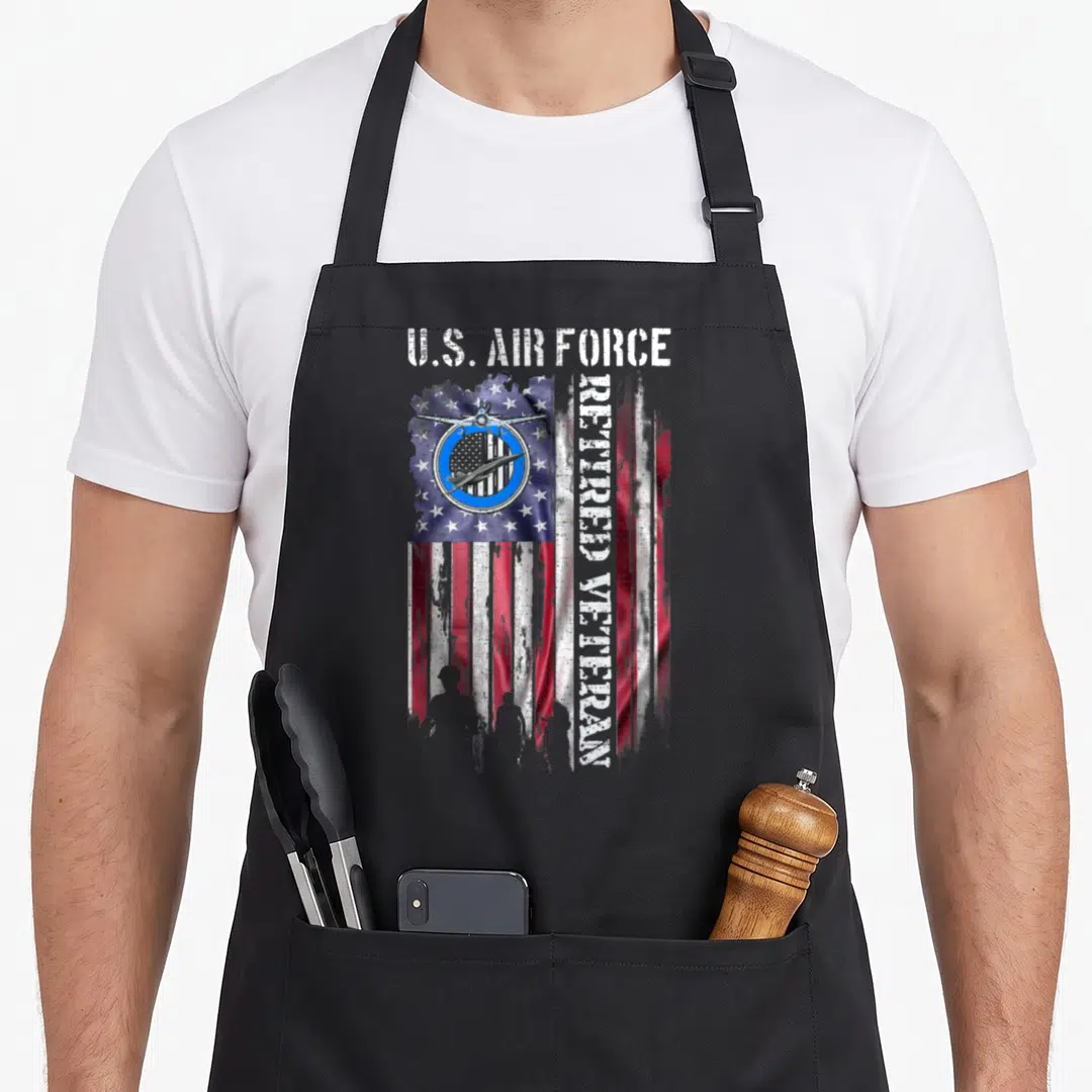 Air force american flag apron - Distressed US flag with U.S. AIR FORCE text, retired veteran vertical text — shown on a black cotton canvas apron against a white background