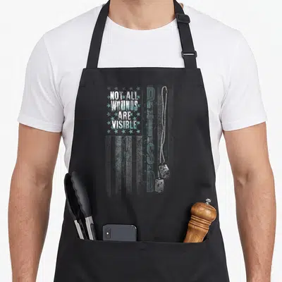 Visible ptsd awareness apron - Stacked text Not All Wounds Are Visible next to vertical PTSD and pair of dog tags — shown on a black cotton canvas apron against a white background
