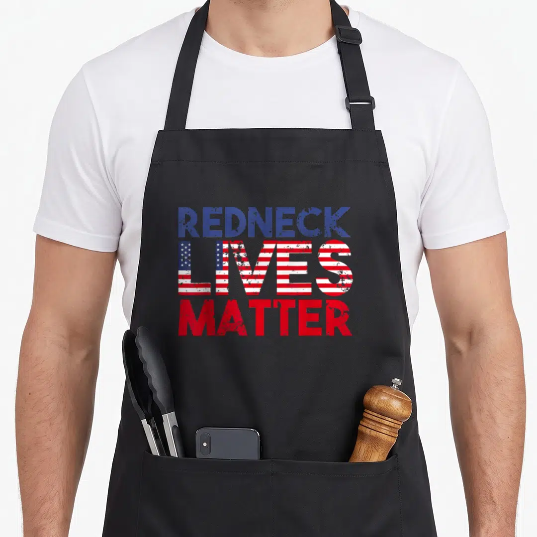 Holiday 4th of july apron - Stacked red white blue distressed text reading Redneck Lives Matter — shown on a black cotton canvas apron against a white background