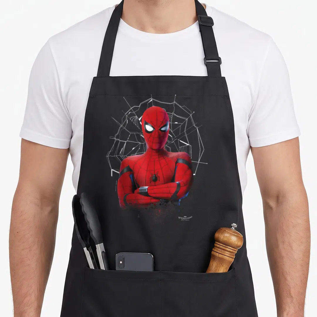 Sarcasm homecoming apron - Spider-Man photo with crossed arms and stylized white web background in red and black colors — shown on a black cotton canvas apron against a white background