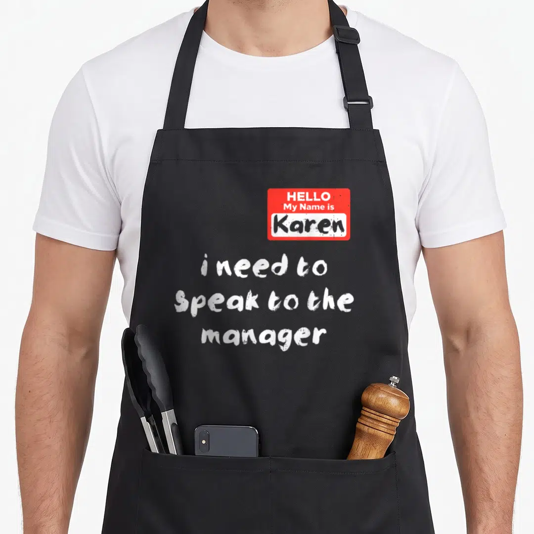 Hello halloween apron - Red name tag and distressed white text i need to speak to the manager on black fabric — shown on a black cotton canvas apron against a white background