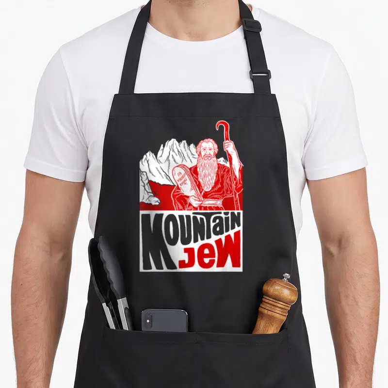 Mountain love jewish apron - Red and white line art of bearded man holding tablets below MOUNTAIN JEW text — shown on a black cotton canvas apron against a white background