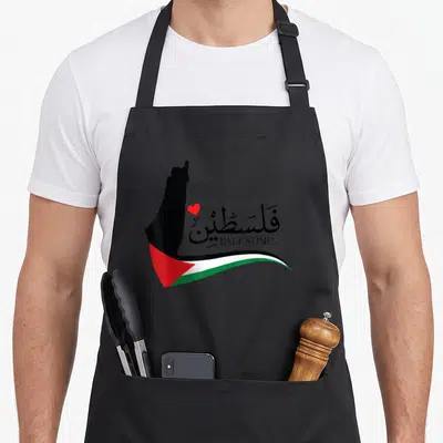 Jerusalem palestine apron - Black map silhouette next to Arabic text, red heart, and waving flag stripes in red white — shown on a black cotton canvas apron against a white background