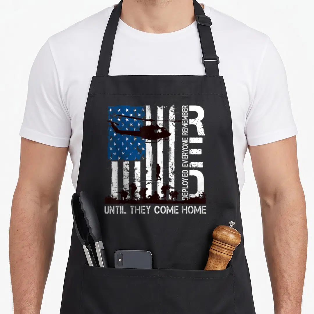 Friday r aprons - Distressed flag helicopter soldier silhouettes DEPLOYED EVERYONE REMEMBER UNTIL THEY COME HOME text — shown on a black cotton canvas apron against a white background