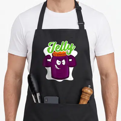 Jelly grapes apron - Cartoon purple jelly jar with muscular arms, green arched Jelly text, orange lid on white — shown on a black cotton canvas apron against a white background