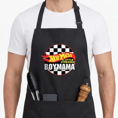 Mess mama apron - Hot Mess A Little Stressed BOYMAMA text on checkered circle with red flame — shown on a black cotton canvas apron against a white background