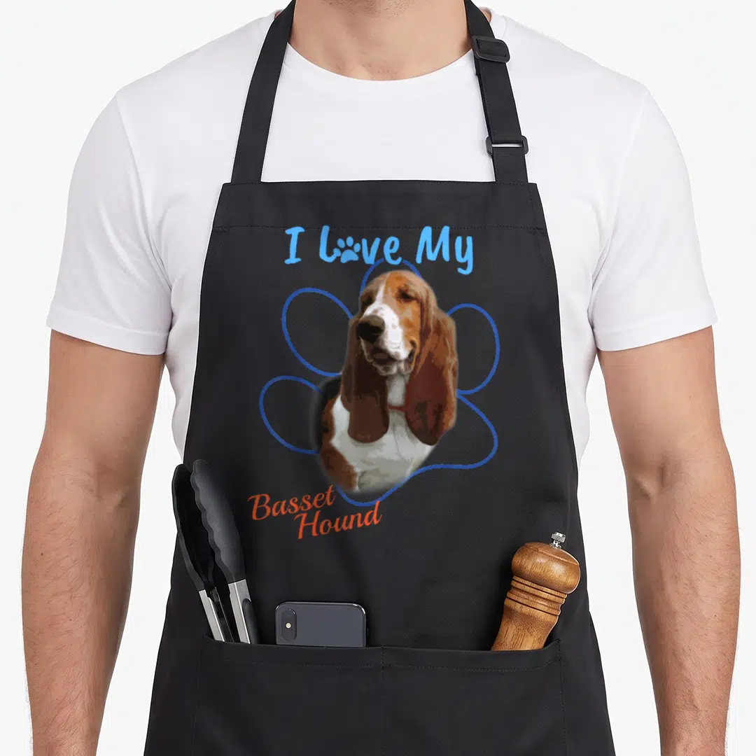 Hound paw dog apron - Basset Hound portrait inside blue paw outline with I Love My text — shown on a black cotton canvas apron against a white background