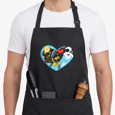 Wall valentine's day apron - WALL-E and EVE inside blue heart with W+E text, light bulb, and potted plant in cartoon — shown on a black cotton canvas apron against a white background