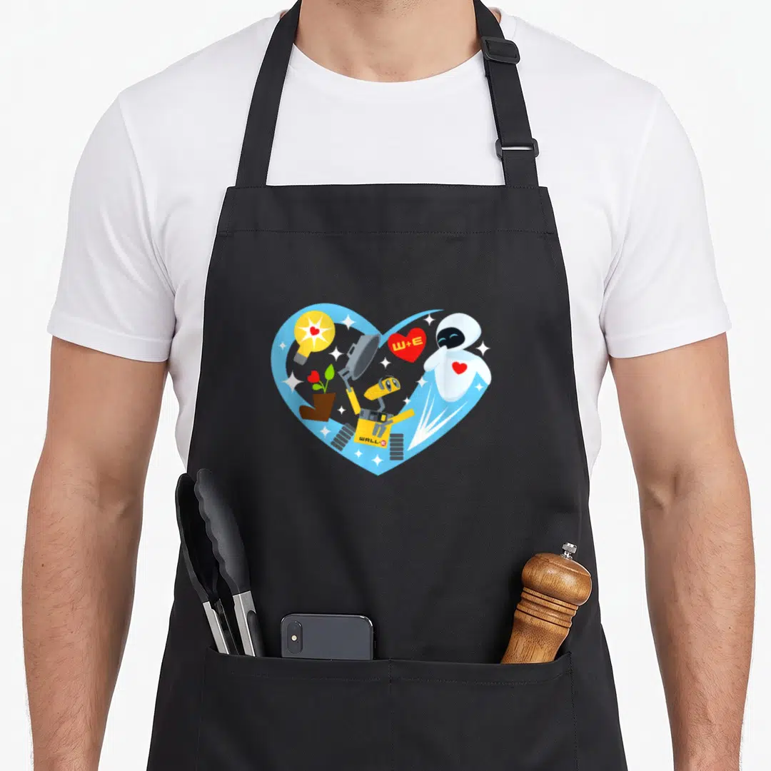 Wall valentine's day apron - WALL-E and EVE inside blue heart with W+E text, light bulb, and potted plant in cartoon — shown on a black cotton canvas apron against a white background